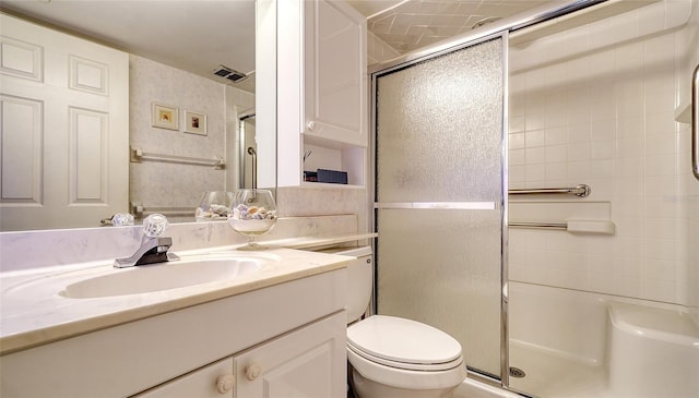 bathroom with vanity, toilet, and an enclosed shower