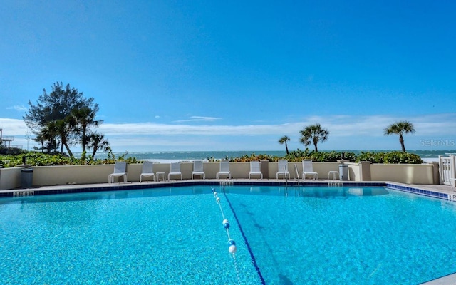 view of pool featuring a water view