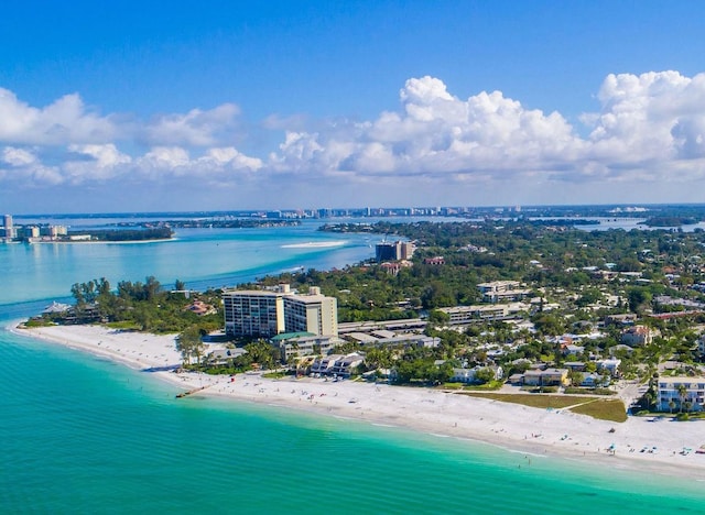 bird's eye view featuring a water view and a beach view