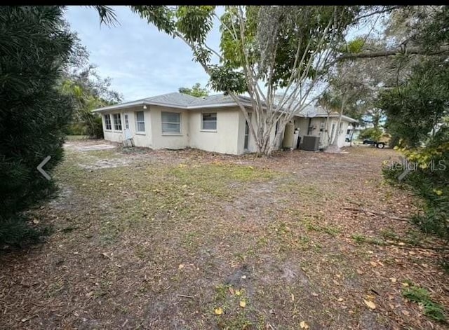 rear view of property featuring cooling unit