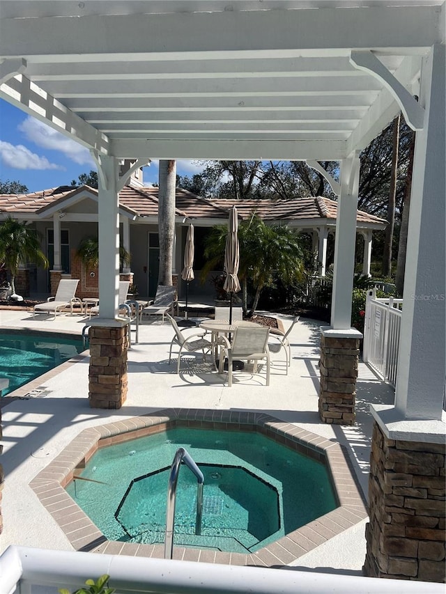 view of swimming pool with an in ground hot tub and a patio