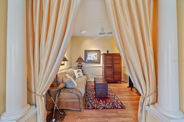 living area with hardwood / wood-style floors and ceiling fan