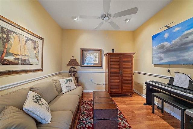 living room featuring ceiling fan and light wood-type flooring