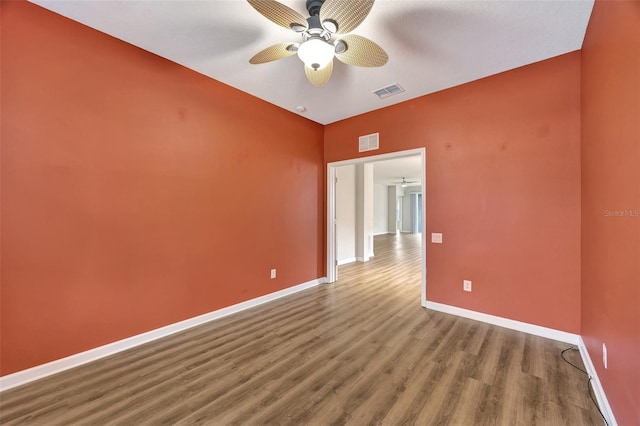 empty room with ceiling fan and light hardwood / wood-style flooring