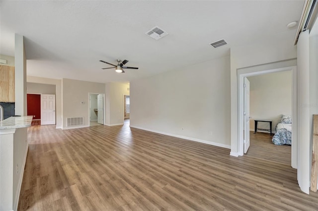 unfurnished living room featuring light hardwood / wood-style floors and ceiling fan