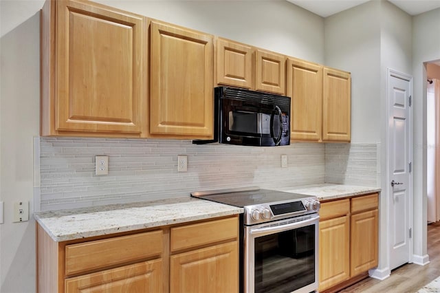 kitchen featuring light hardwood / wood-style floors, light stone countertops, stainless steel range with electric stovetop, and backsplash