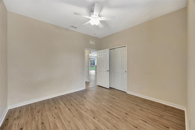 unfurnished bedroom featuring a closet, ceiling fan, and light hardwood / wood-style flooring