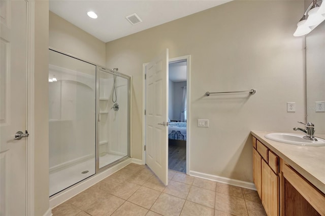 bathroom featuring walk in shower, vanity, and tile patterned floors