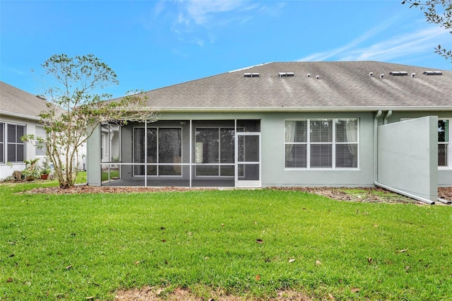 10444 48th Ct E, Parrish, FL 34219 - rear view of property featuring a sunroom, a lawn, a shingled roof, and stucco siding
