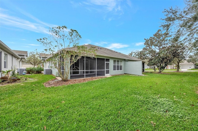 10444 48th Ct E, Parrish, FL 34219 - rear view of house with a lawn, a sunroom, and central air condition unit