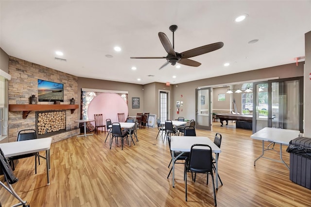 10444 48th Ct E, Parrish, FL 34219 - dining space featuring ceiling fan, light wood finished floors, a stone fireplace, plenty of natural light, and recessed lighting