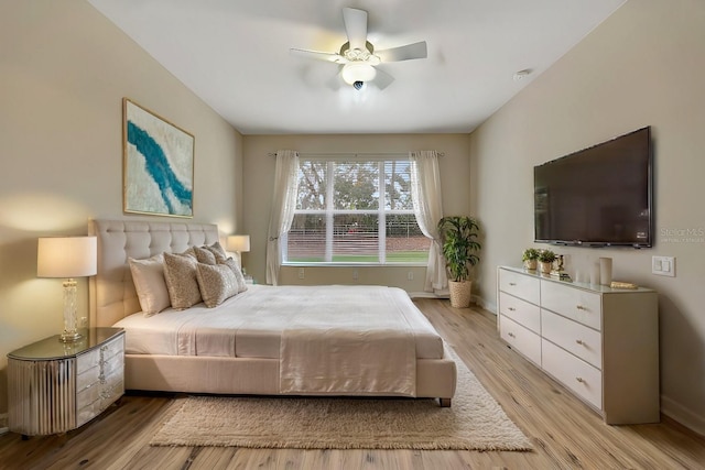 bedroom with light hardwood / wood-style floors and ceiling fan