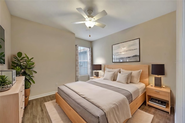 bedroom with hardwood / wood-style floors and ceiling fan