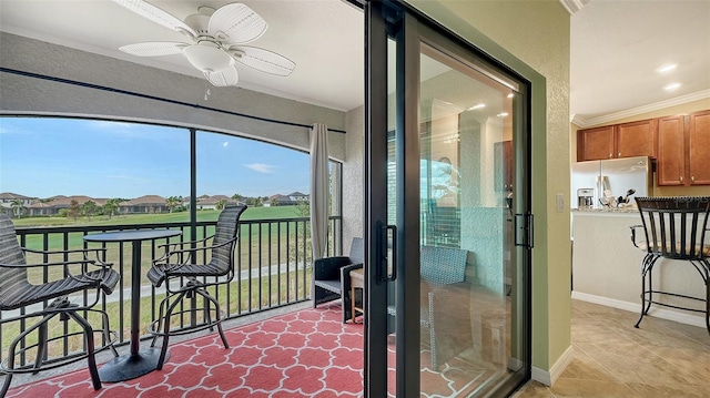 sunroom featuring ceiling fan