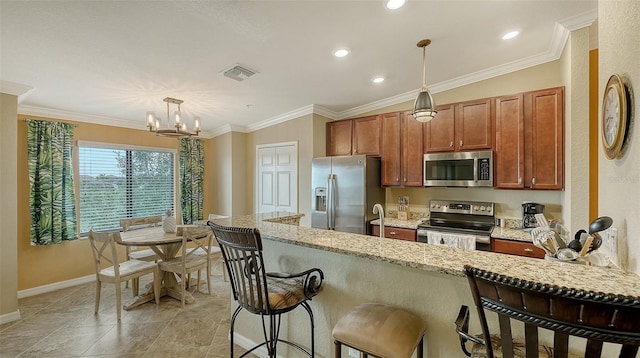 kitchen featuring light stone countertops, stainless steel appliances, crown molding, pendant lighting, and a chandelier