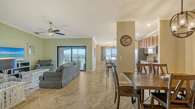 dining room featuring ceiling fan with notable chandelier and crown molding