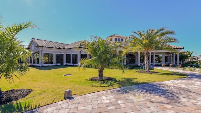 rear view of house featuring a yard