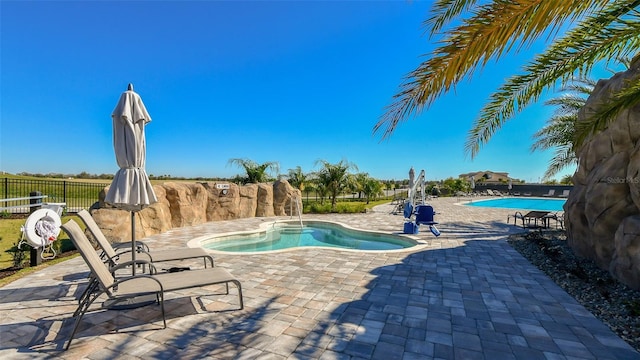 view of swimming pool with a patio