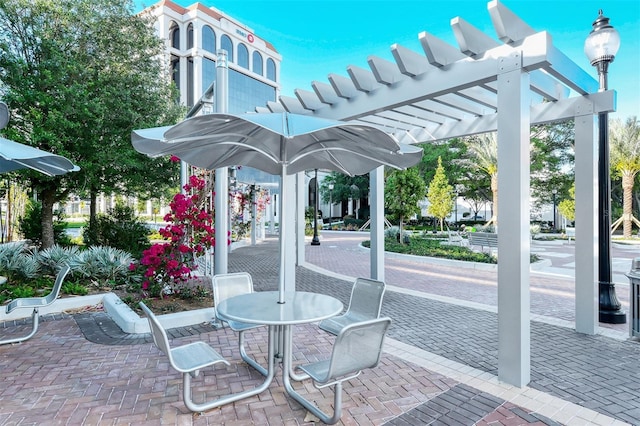 view of patio / terrace with a pergola and outdoor dining area