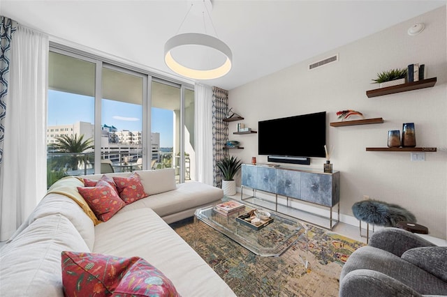 living room featuring floor to ceiling windows