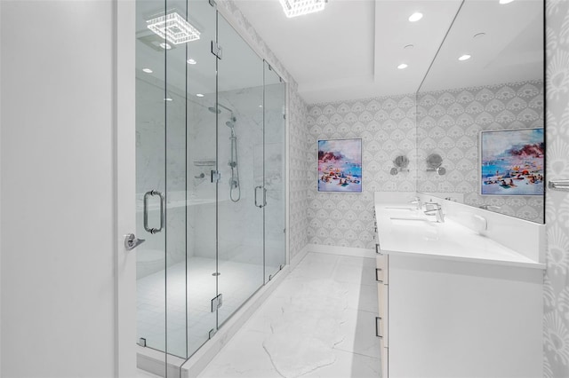 bathroom featuring walk in shower and vanity