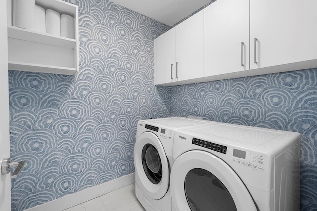 laundry area featuring separate washer and dryer and cabinets