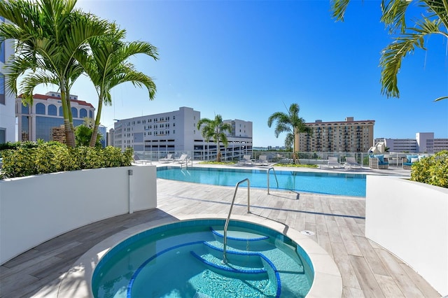 view of pool with a hot tub