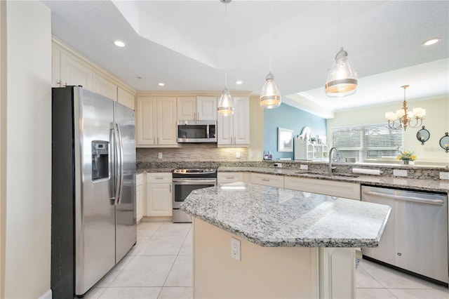 kitchen featuring stainless steel appliances, a center island, sink, and hanging light fixtures