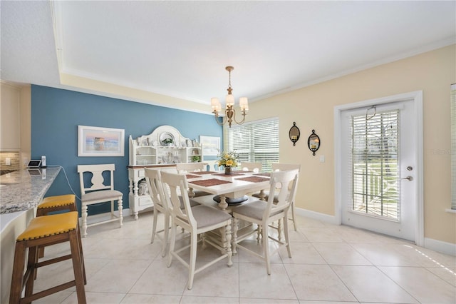 dining room featuring light tile patterned flooring, plenty of natural light, a chandelier, and crown molding