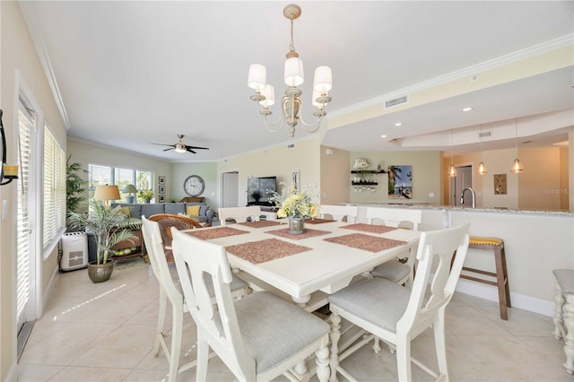 dining area with light tile patterned floors, ceiling fan with notable chandelier, and ornamental molding