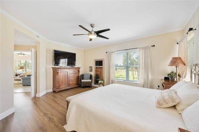 bedroom with ceiling fan, ornamental molding, and light hardwood / wood-style flooring