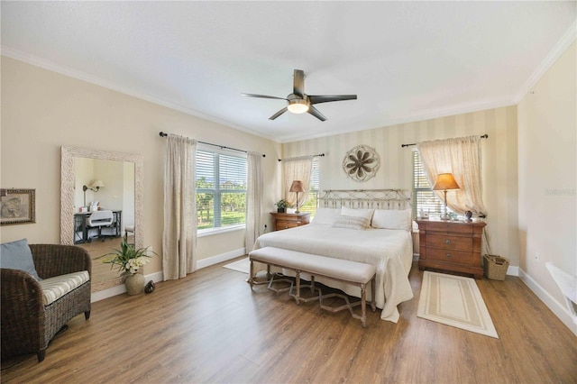 bedroom with hardwood / wood-style flooring, ornamental molding, and ceiling fan