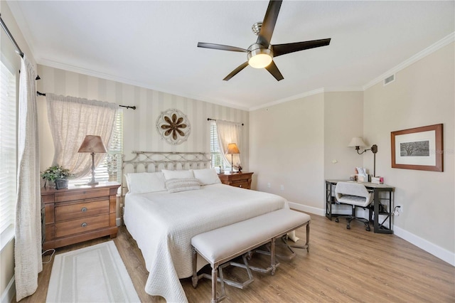 bedroom with hardwood / wood-style flooring, ornamental molding, and ceiling fan