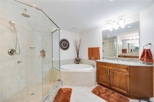 bathroom featuring tile patterned flooring, vanity, independent shower and bath, and a textured ceiling