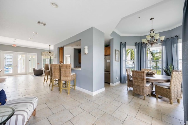 dining space with light tile patterned floors, a notable chandelier, and french doors