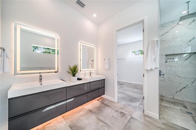 bathroom featuring vanity and tiled shower