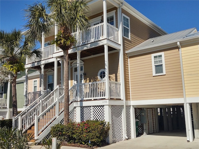 exterior space with a porch, a balcony, and a carport