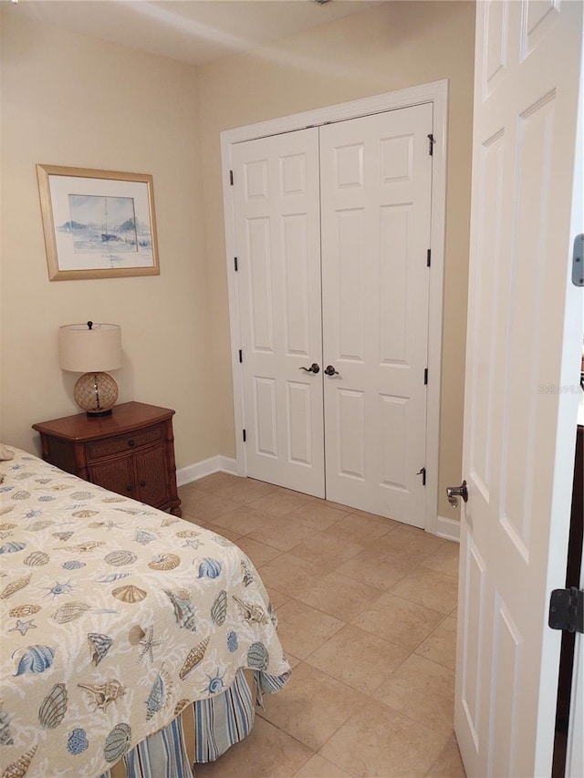 bedroom featuring a closet and light tile patterned floors