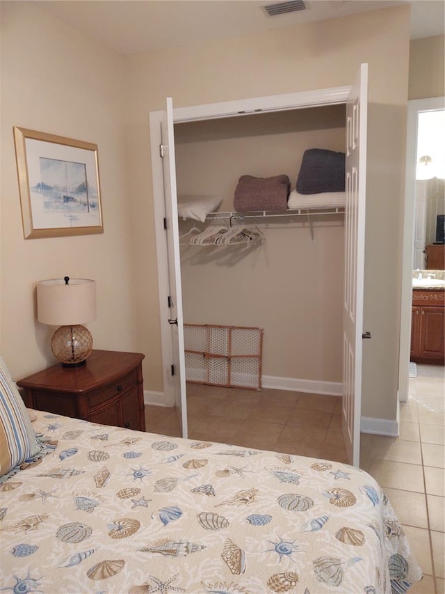 tiled bedroom featuring sink and connected bathroom