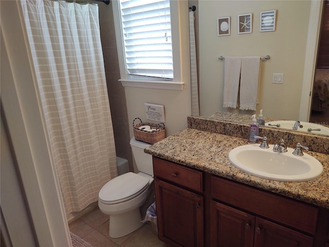 bathroom with vanity, toilet, and tile patterned flooring