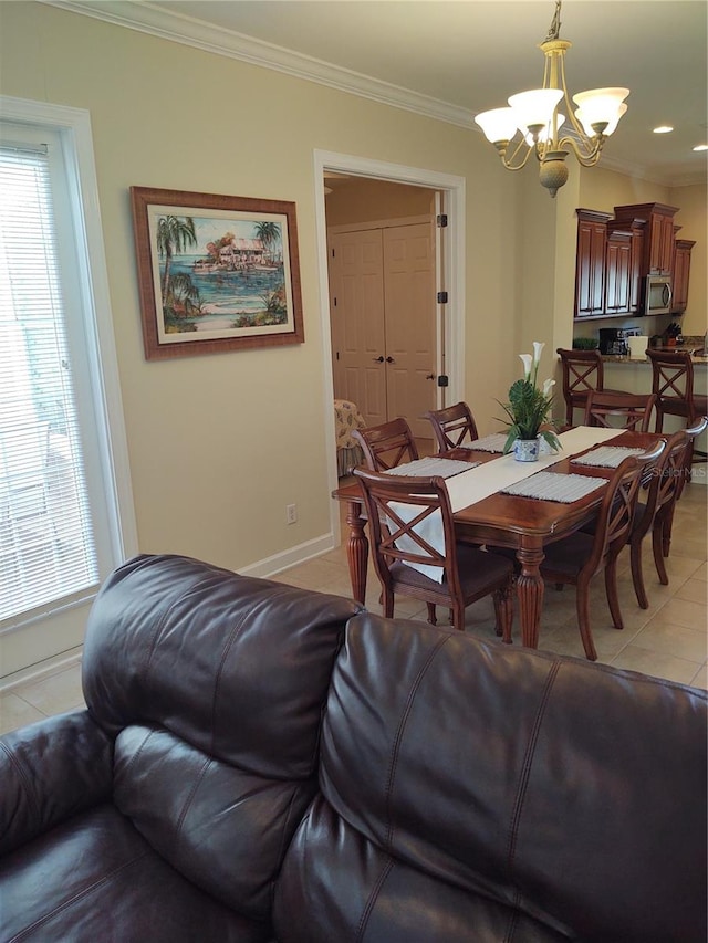 tiled dining space with ornamental molding and an inviting chandelier