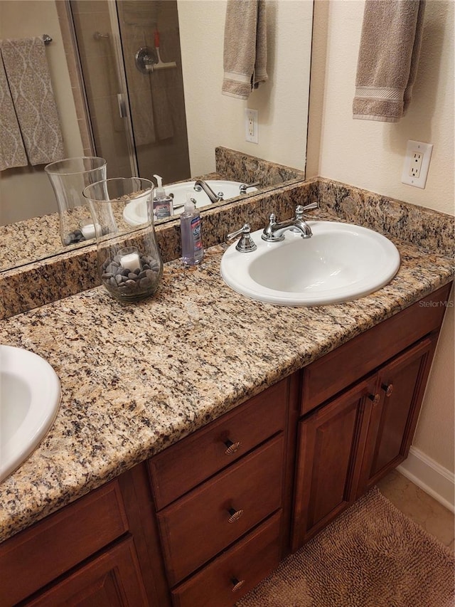 bathroom with vanity and an enclosed shower