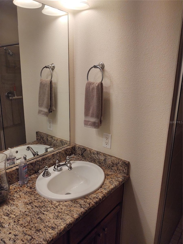 bathroom with vanity and walk in shower