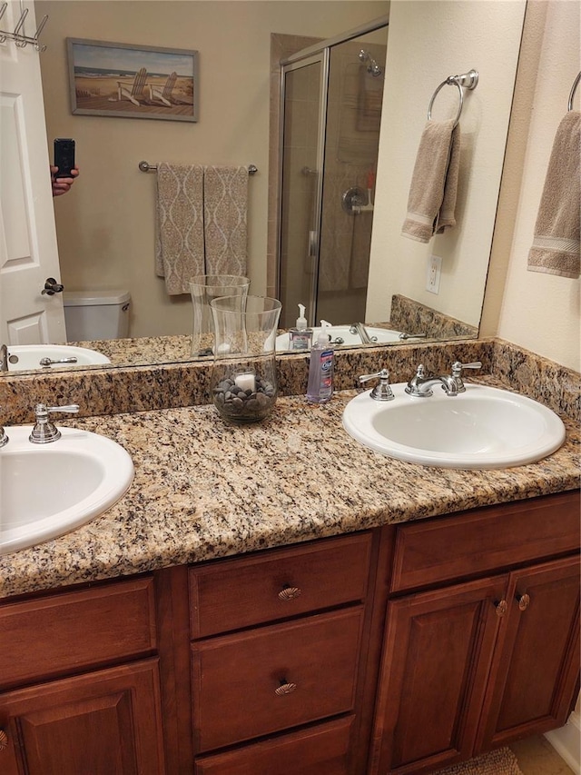 bathroom with vanity, an enclosed shower, and toilet