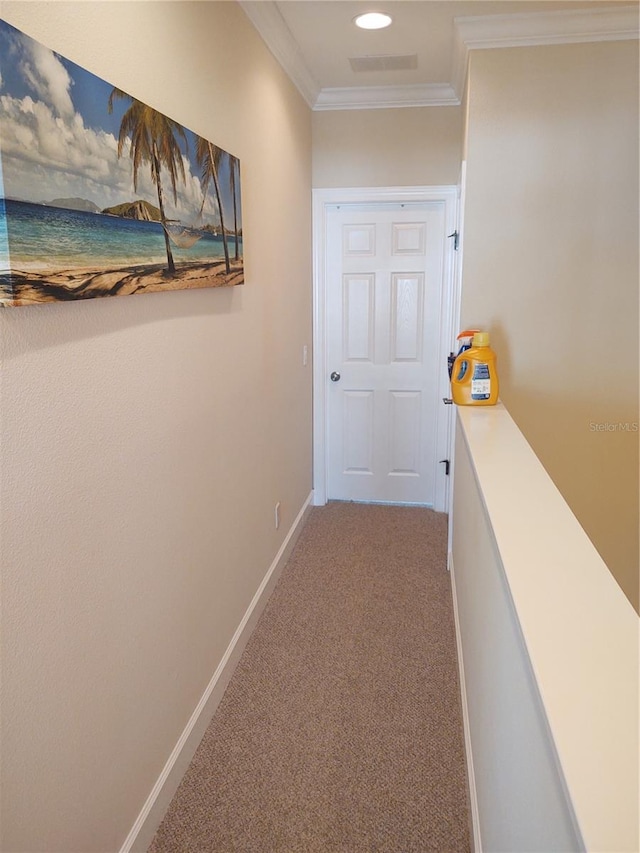 hall featuring ornamental molding and carpet floors