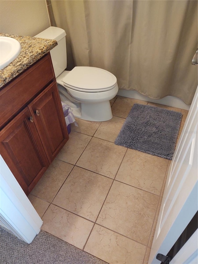 bathroom with vanity, toilet, and tile patterned flooring