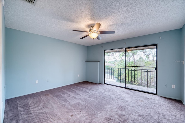 unfurnished room with ceiling fan, a textured ceiling, and carpet flooring