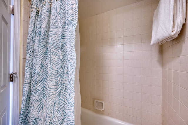 bathroom with shower / bathtub combination with curtain