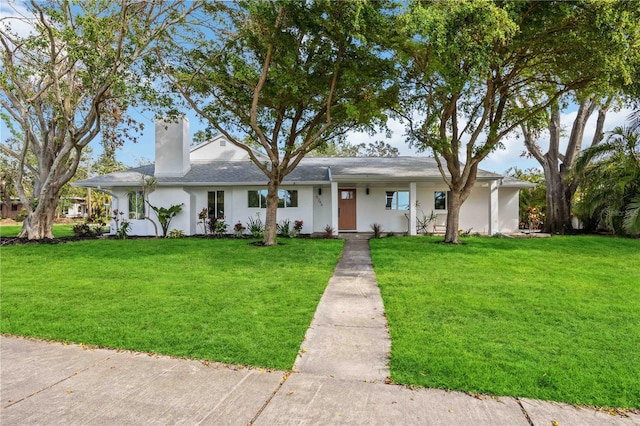 single story home featuring a front lawn