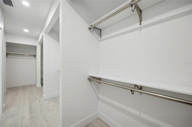 spacious closet featuring light wood-type flooring